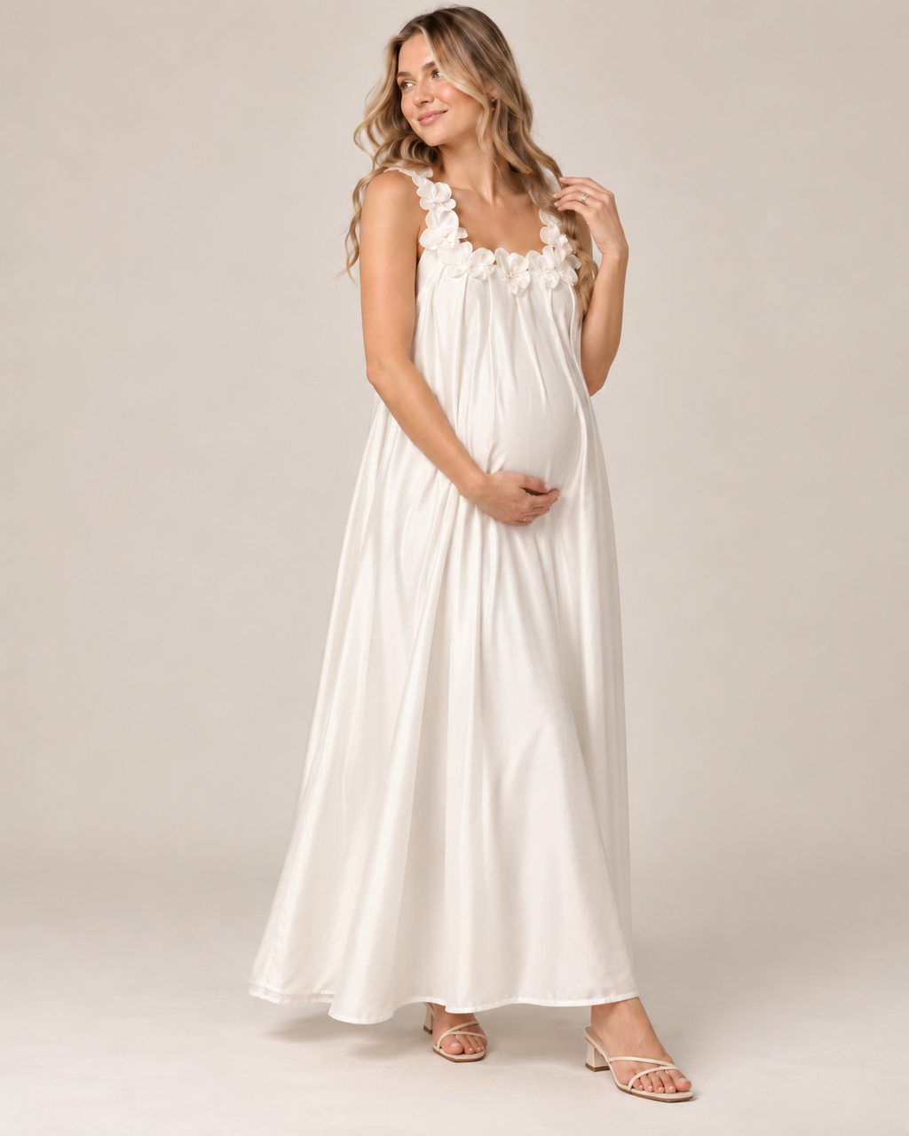 Woman in a white ruffle-strap maternity maxi dress