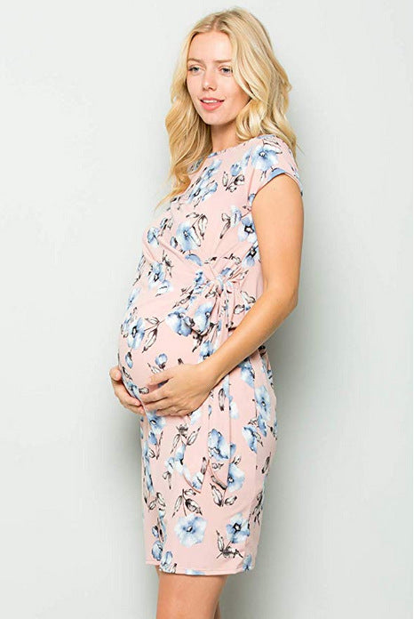 Pregnant woman in a pink floral side-tie maternity dress 